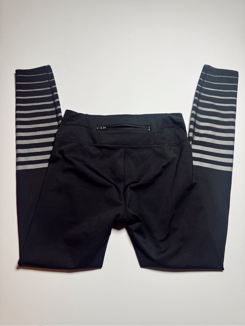 Athleta Black leggings with stripes down the leg